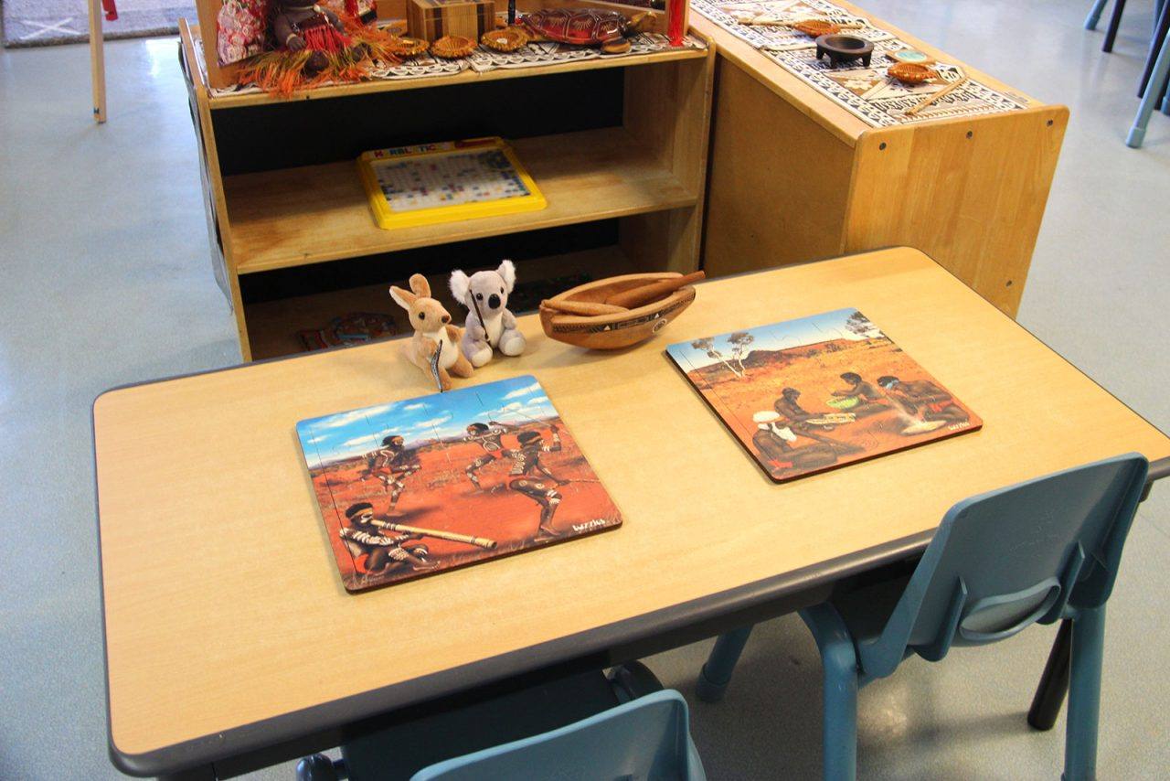 A First Nations cultural learning setup in the Rainbow Room, with Aboriginal puzzles and Australian native animal toys